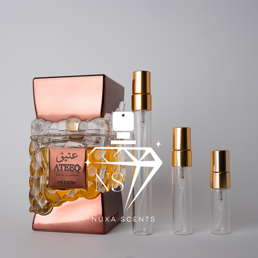 Perfume bottles with gold caps and nusuk branding on a gray background