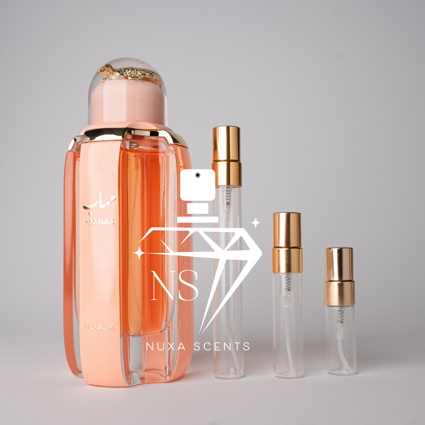 Nuxe Scents perfume bottles with gold caps on a gray background