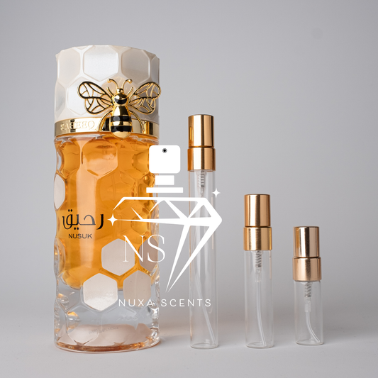  perfume bottle with gold cap and honeycomb design on a gray background