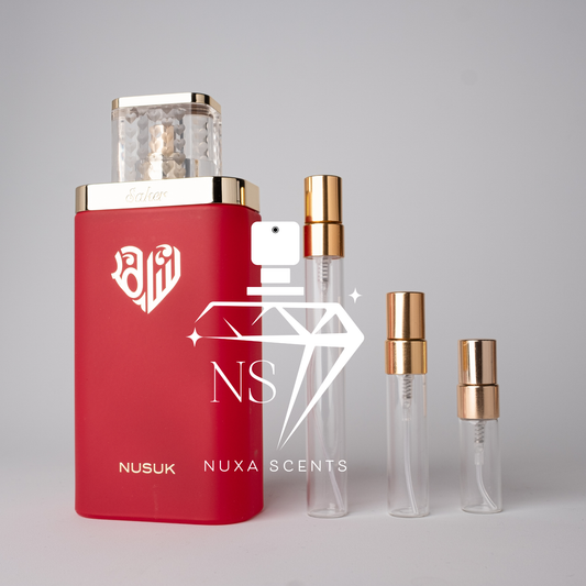 Red Nusuk perfume bottle with gold caps on a gray background