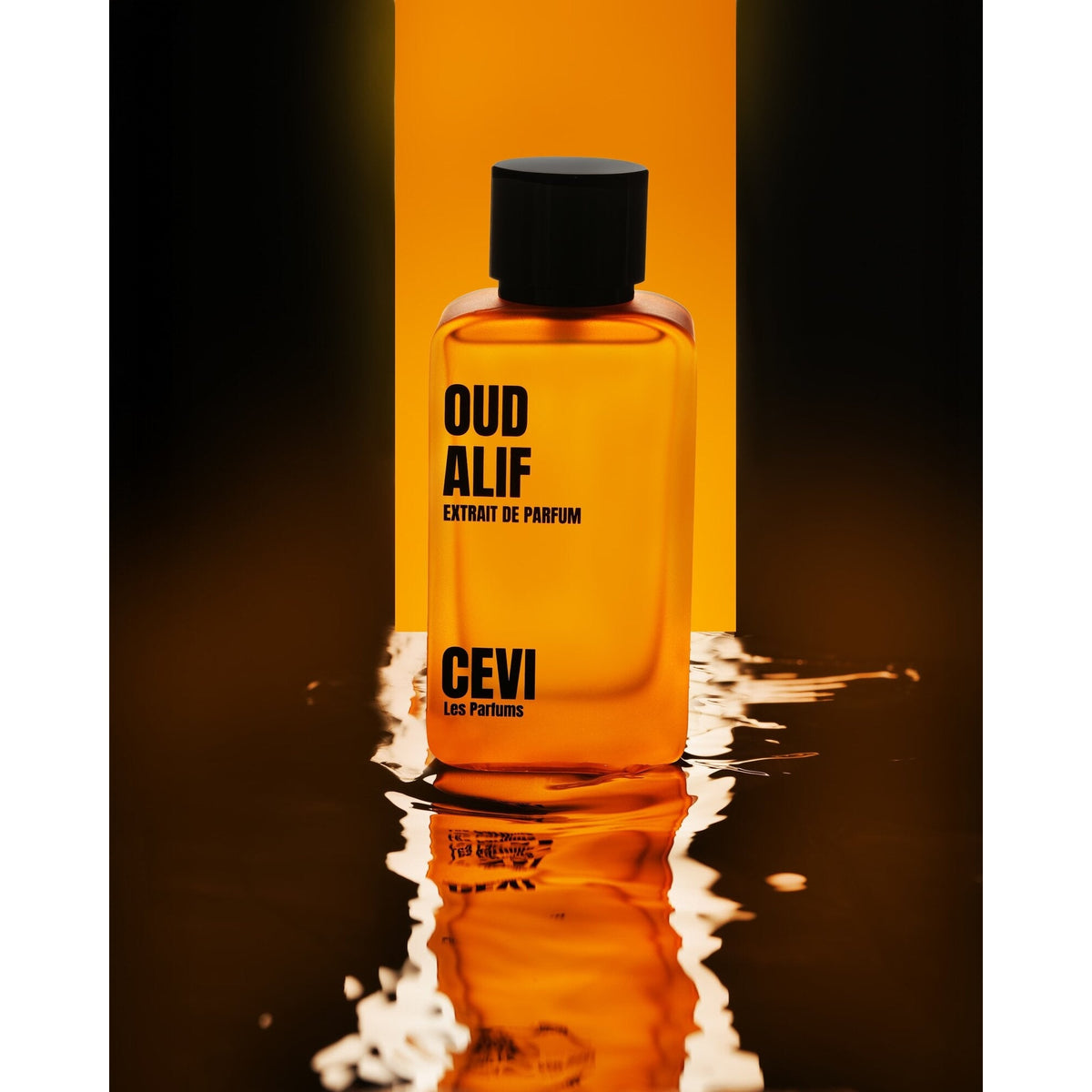 Cevi Oud Alif Extrait de Parfum amber bottle with black cap standing in rippling water against an orange backdrop