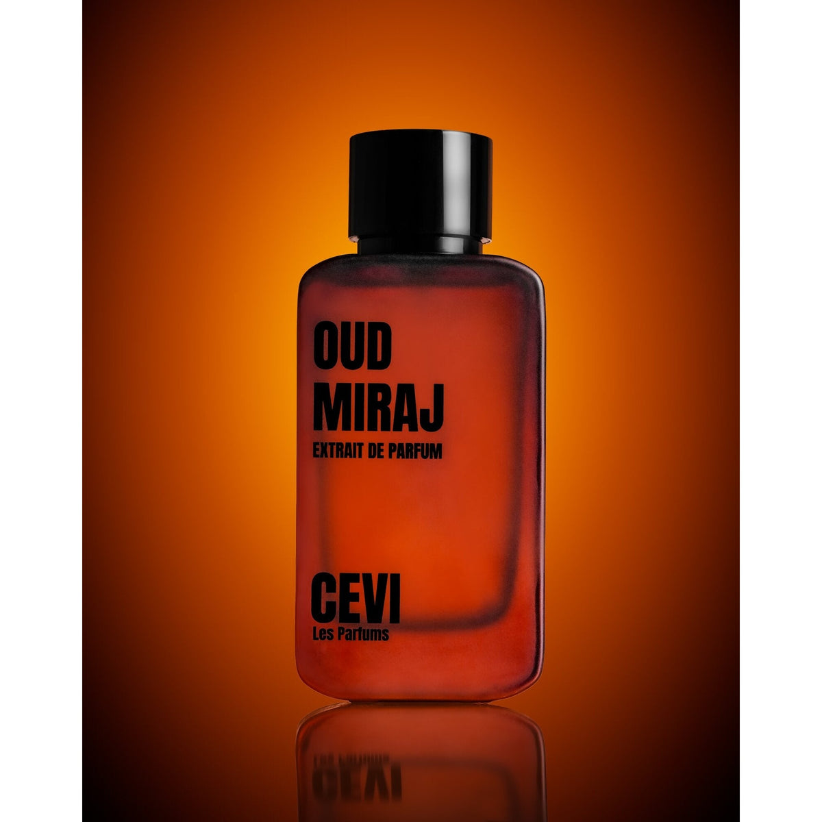 Oud Miraj by Cevi Les Parfums 100ml extrait de parfum bottle against a warm orange background with a mirrored reflection