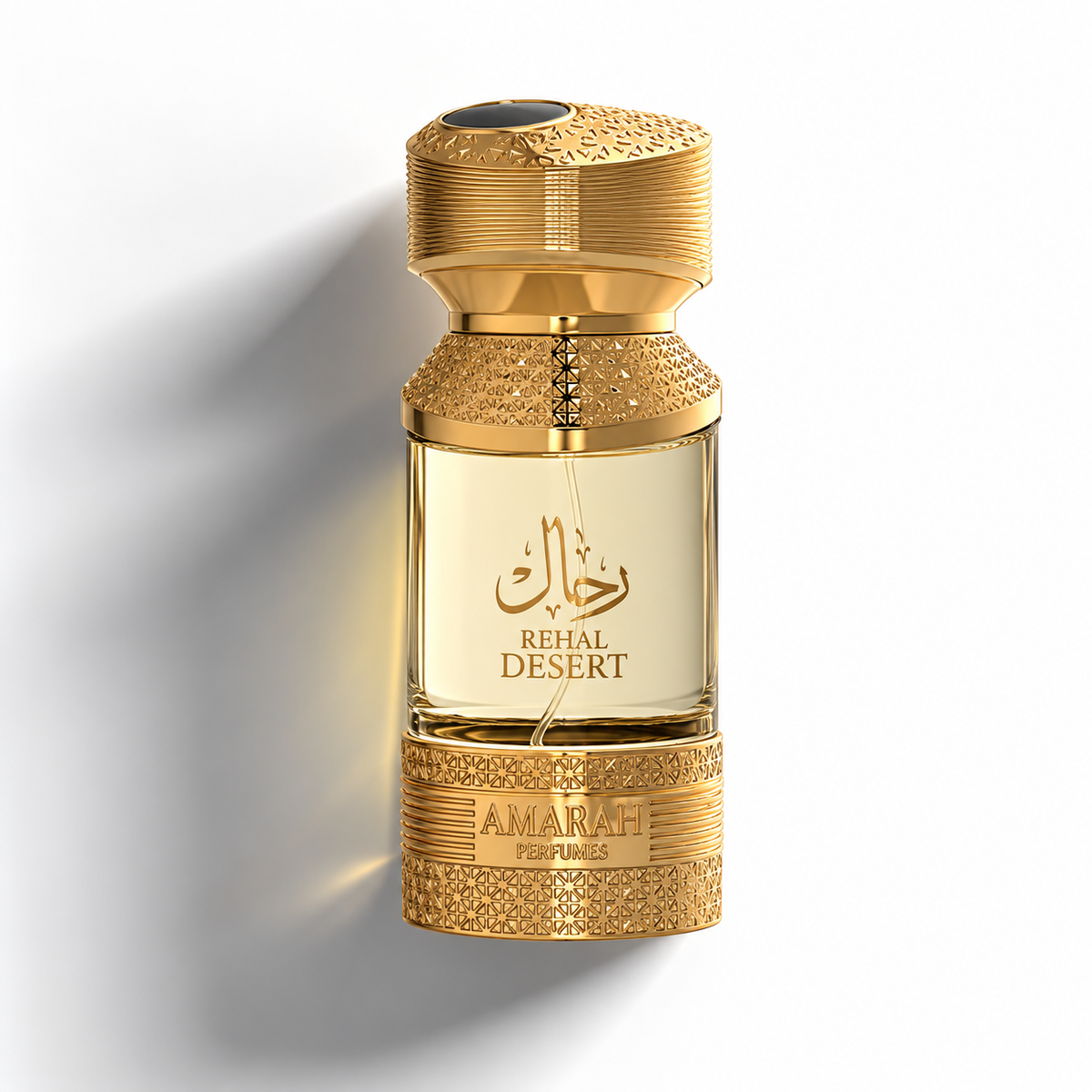 A luxury perfume bottle for 'Rehal Desert' by 'Amarah Perfumes', featuring a textured gold-tone metal cap and base with a clear glass bottle containing a pale golden-yellow liquid. The bottle is centered against a clean white background with a soft shadow.