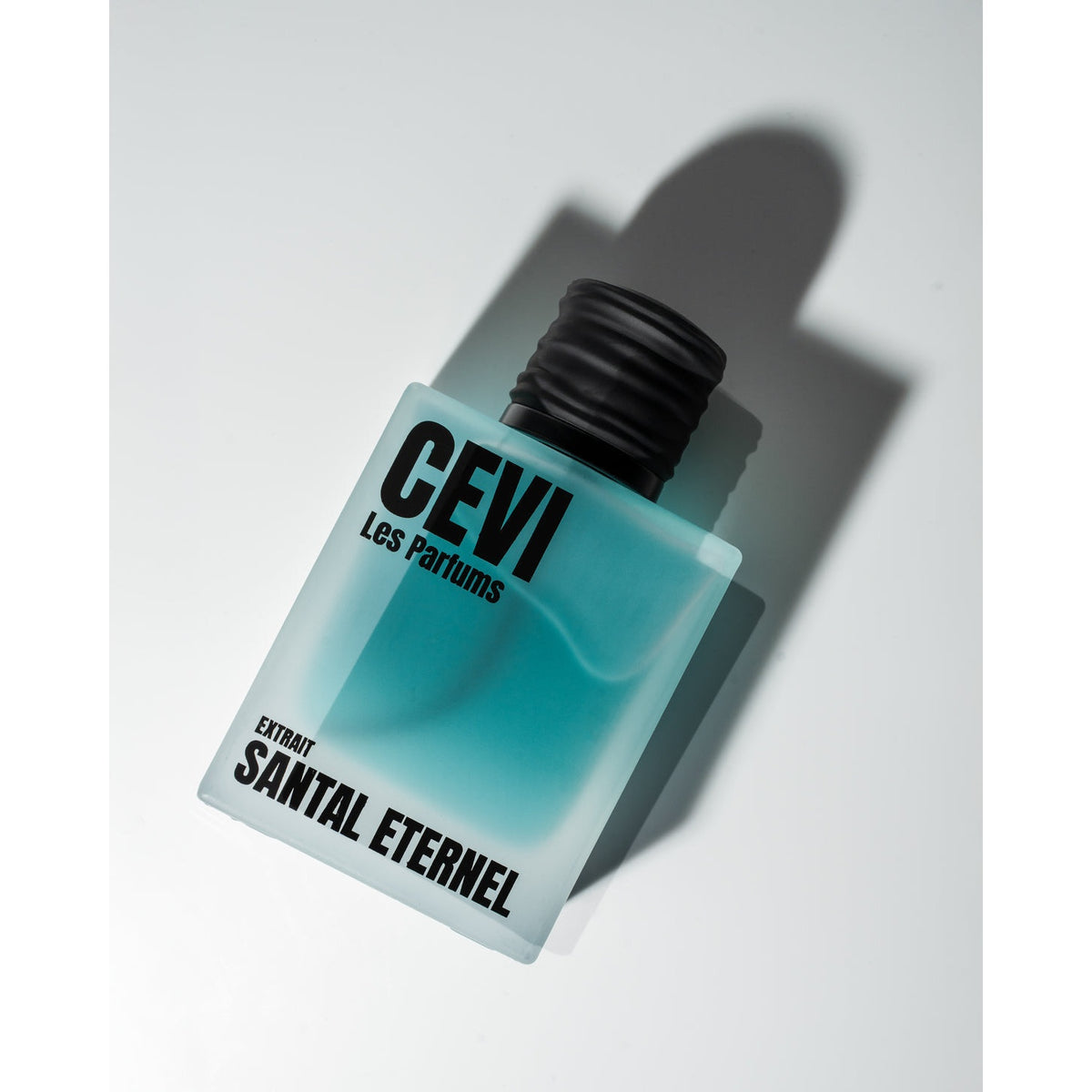 Santal Eternel by Cevi Les Parfums frosted blue bottle angled with shadow | Nuxa Scents