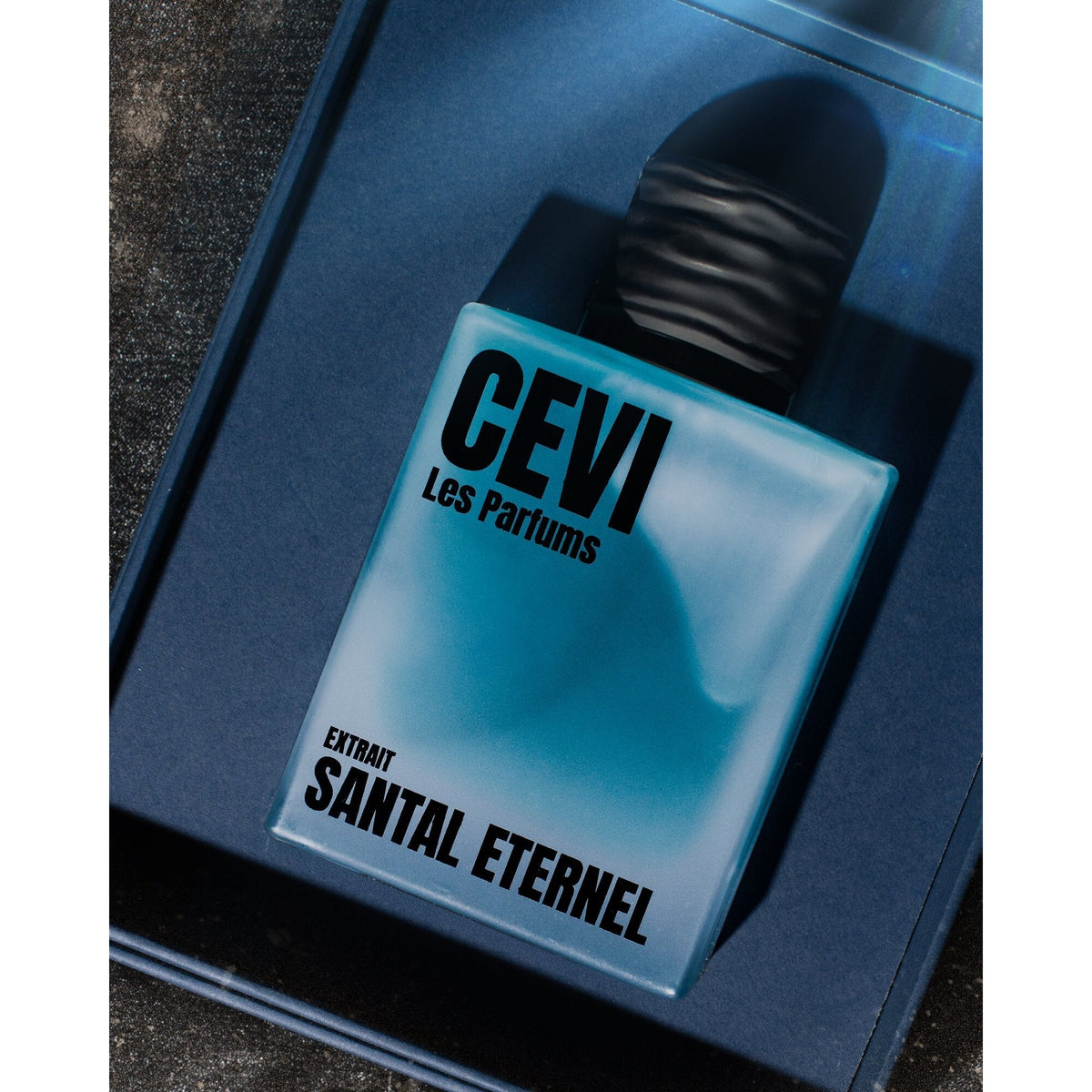 Santal Eternel by Cevi Les Parfums bottle resting in its open dark blue box | Nuxa Scents