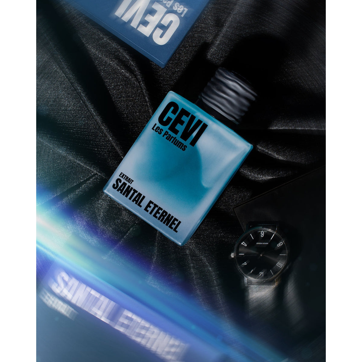 Santal Eternel by Cevi Les Parfums bottle on dark fabric with watch, lifestyle photo | Nuxa Scents