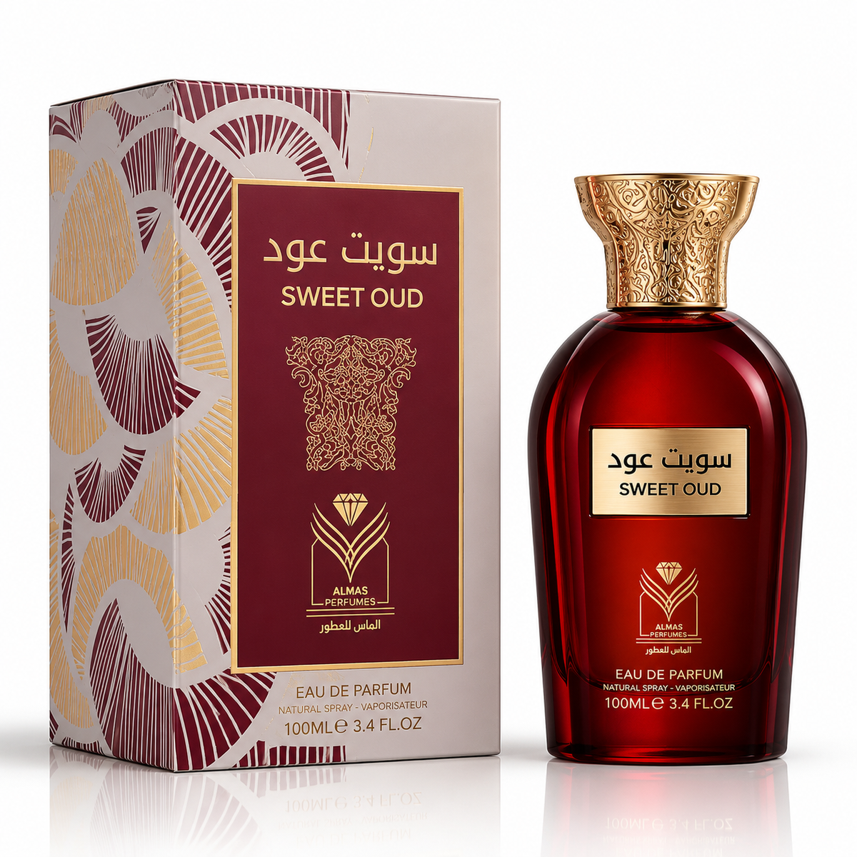 Suede Oud Eau de Parfum bottle and its packaging box by Almas Perfumes, featuring a deep red translucent bottle with a gold cap and a box with a maroon and gold geometric pattern.